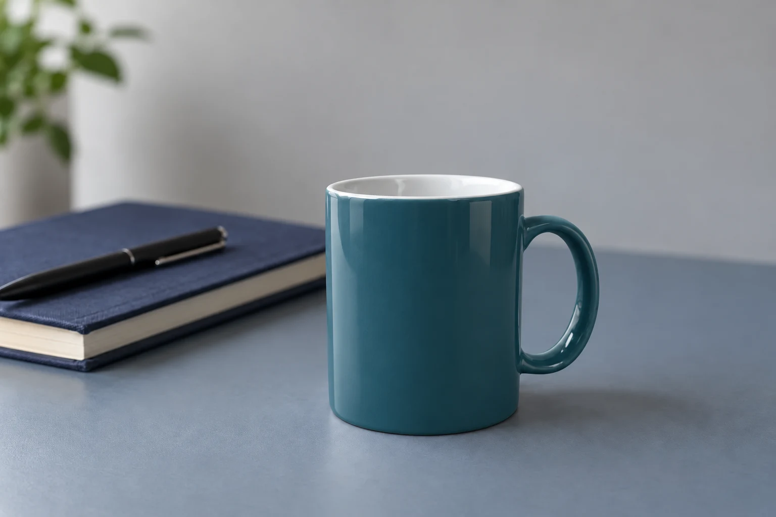 Teal recoloring of the mug exterior and handle, with a white interior and a navy notebook on the blue-gray desk