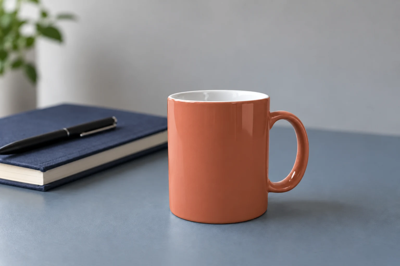 Terracotta recoloring of the same mug exterior and handle, retaining the white interior and the desk arrangement